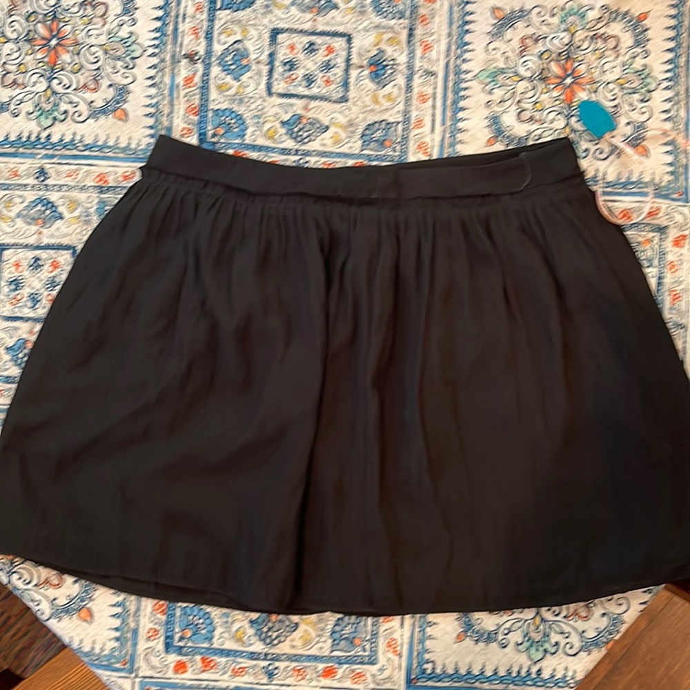 Short black pleated skirt